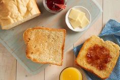 bread, butter and jam are on a cutting board