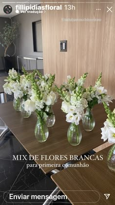 flowers are arranged in vases on a table