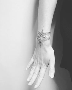 a woman's arm with a tattoo on it and a cross in the middle