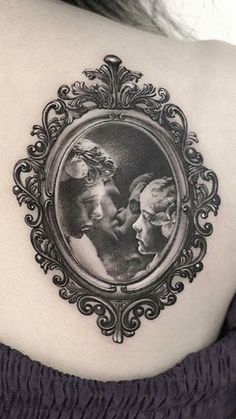 a woman's back shoulder with an image of two people in a frame on it