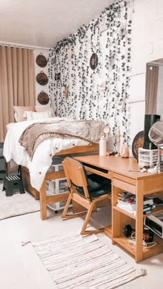 a bedroom with a bed, desk and chair next to a wallpapered wall