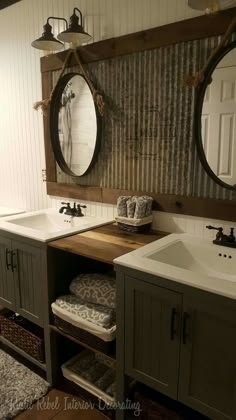 a bathroom with two sinks and mirrors on the wall