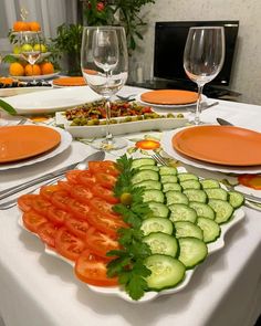 the table is set with many different types of food and wine glasses on top of it