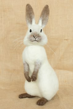 a stuffed rabbit sitting on its hind legs