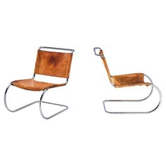 two chairs made out of wood and metal