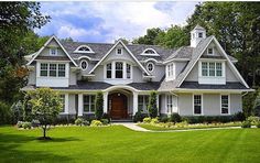 a large gray house with white trim and windows