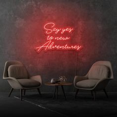 two chairs in front of a neon sign that says i liked it so it's mine