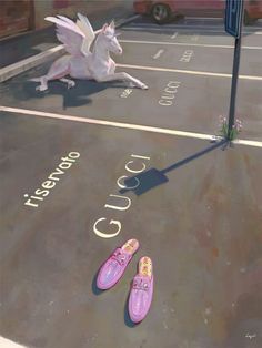 two pink shoes laying on the ground next to a unicorn