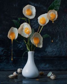 four eggs are placed on top of each other in a vase