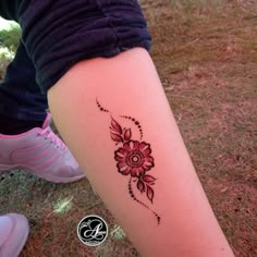 a woman's leg with a flower tattoo on it