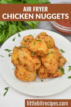 air fryer chicken nuggets on a white plate with parsley and ketchup