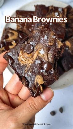 a hand holding a chocolate brownie with peanut butter on top and the words banana brownies above it