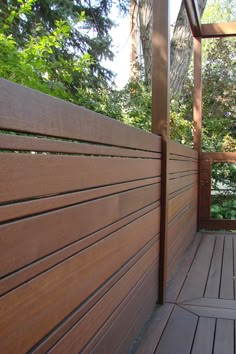 a wooden fence is next to a wood deck