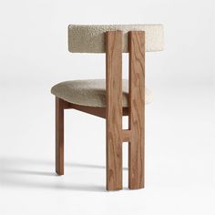 a chair made out of wood and fabric with a white seat cushion on the back