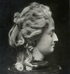 an old black and white photo of a woman's head