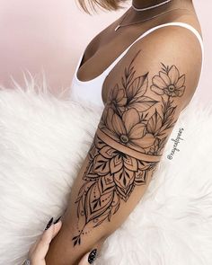 a woman with a flower tattoo on her arm