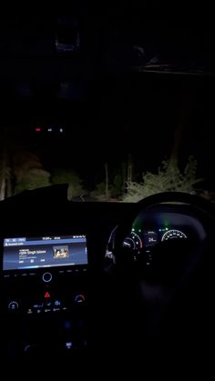 the interior of a car at night with its lights on and dashboard illuminated by an appliance