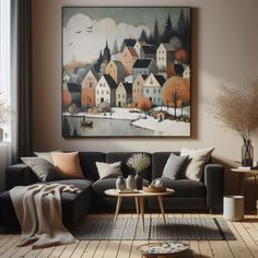 a living room filled with furniture and a painting hanging on the wall over a wooden floor