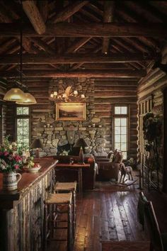 the interior of a log cabin with stone walls