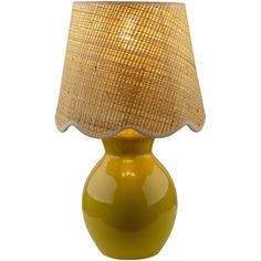 a yellow table lamp with a beige shade on it's side and a white background