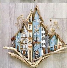 there is a bird flying over a house made out of driftwood and wood sticks