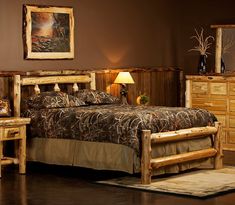 a bed room with a neatly made bed and dressers