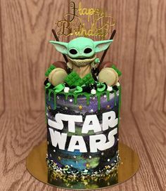 a star wars themed birthday cake with an yoda figure on top and the words happy birthday