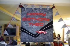 a birthday banner with a race car on it