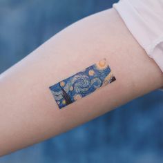 a person's arm with a starry night painting on the left side of their arm