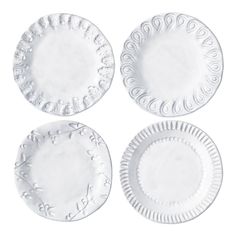 four white paper plates sitting on top of each other