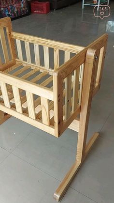 a wooden baby crib sitting on top of a floor