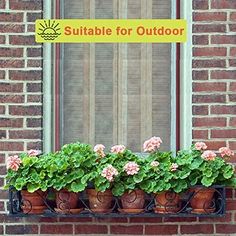 there is a sign that says suitable for outdoor with potted flowers on the window sill