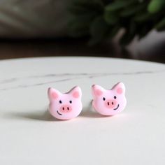 DAINTY pink piggy earrings!  Measures just 7mm approx.  Hand painted tiny details to bring a smile! Titanium posts for sensitive ears and comfy fit.  Earrings are so lightweight you'll forget you're wearing them!  Finished with a beautiful, glossy finish. // Info: * Titanium posts * 100% Nickel-free * Hypoallergenic for sensitive ears * Hand sculpted, ultra lightweight + unique designs! We always include a pair of spare rubber backings with each order. ♥ // Stud earrings by PitterPatterPolymer here: https://www.etsy.com/shop/PitterPatterPolymer?ref=hdr_shop_menu&section_id=15736817 Pet Pig, Pig Earrings, Multiple Earrings, Pet Pigs, Titanium Earrings, Earring Cards, Earrings Studs, Cat Earrings, Fun Earrings