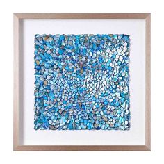 a blue and white mosaic art piece in a wooden frame on a white wall,