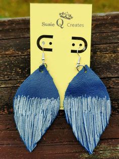 blue and white leather earrings with fringes hanging from the end of each earring