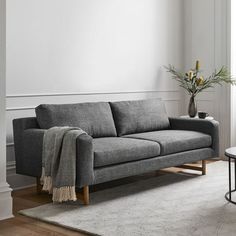 a living room with a gray couch and table