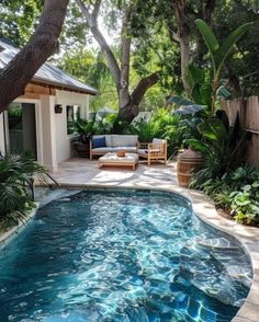 an outdoor swimming pool surrounded by trees and plants