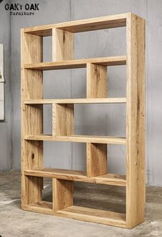 a wooden bookcase sitting on top of a cement floor