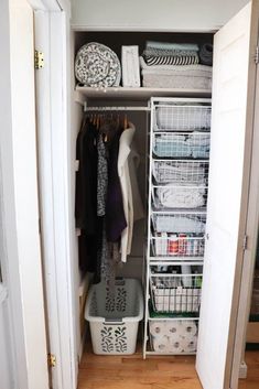 an organized closet with clothes, baskets and other items in it's doors open