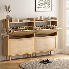 a room with a rug, table and shelves on the wall next to a window