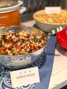 a bowl filled with food sitting on top of a table next to other plates and bowls