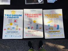 three brochures sitting on top of a sidewalk next to a person's feet