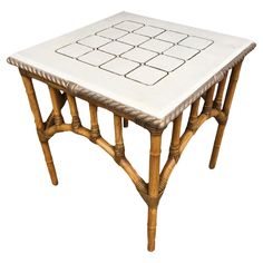 a small table made out of bamboo and white tile