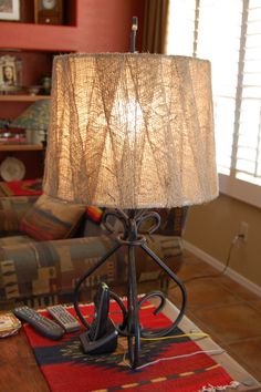 a lamp sitting on top of a table next to a couch