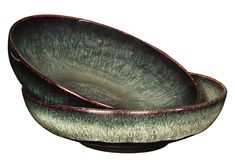 two green and red bowls sitting on top of each other