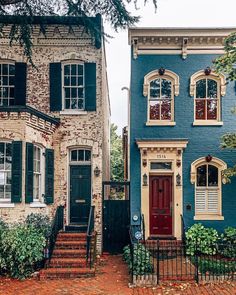 two houses with red doors and green shutters