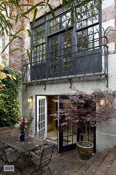 an outdoor patio with table and chairs