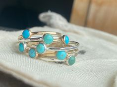 These tiny Turquoise stacking rings are a perfect addition when you want a pop of color in your stack or just a single simple classic turquoise stone. Our rings are made from Argentium silver, which is a higher-grade sterling silver that is more tarnish-resistant. These are also available in Gold Filled which is 100x's thicker than gold-plated. I have customers who have been wearing our gold stackers for more than 4 years with never taking them off and they look as good as the day they bought them and didn't turn their fingers green! Rings Turquoise, Rings Stacking, Stacker Rings, Rings Sterling Silver, Argentium Silver, Turquoise Rings, Women's Jewelry And Accessories, Stackable Rings, Stacking Rings