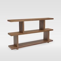 a wooden shelf sitting on top of a white wall