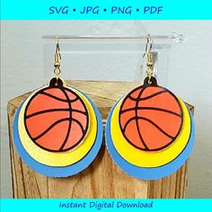 a pair of earrings with a basketball painted on it